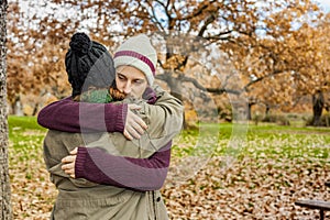 Portrait young couple hugging in an autumn background. Back view
