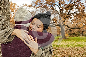 Portrait young couple hugging in an autumn background. Back view