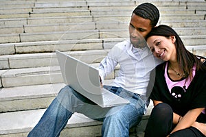 Portrait of a young couple with laptop