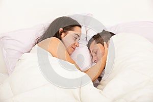 Portrait of a young couple in love in a bed