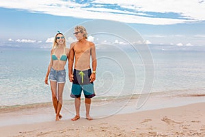 Portrait of young couple in love embracing at beach and enjoying time being together. Idealistic artistic photo poster