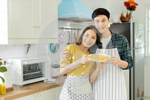 Portrait young couple in love helping to cook In a romantic atmosphere at home with smile face