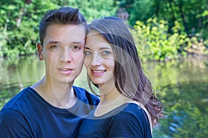 Portrait young couple in love near water