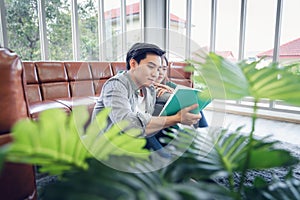 Portrait of Young Couple Love in Romantic Emotions While Reading a Book Together, Couple Young People Having Fan and Relaxing in