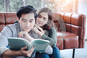 Portrait of Young Couple Love in Romantic Emotions While Reading a Book Together, Couple Young People Having Fun and Relaxing in