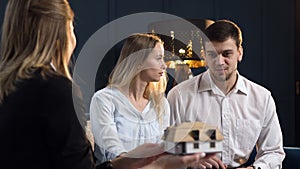 Portrait of young couple on the meeting with architect.