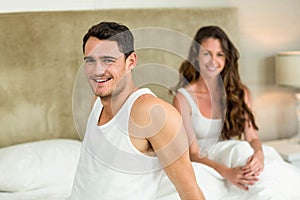 Portrait of young couple relaxing on bed