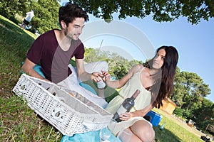 Portrait young couple during romantic picnic in countryside