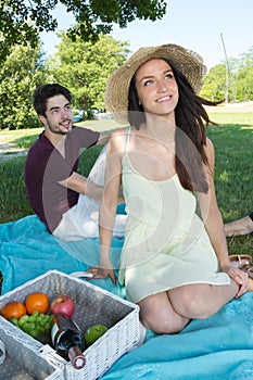 Portrait young couple during romantic picnic in countryside