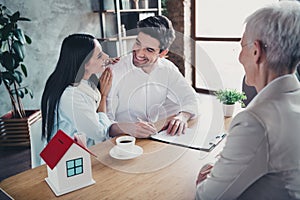 Portrait of young couple sign clipboard document meeting realtor lady desk loft interior office indoors