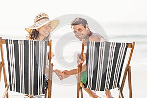 Portrait of young couple sitting on armchair