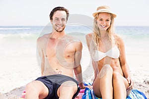 Portrait of young couple sitting on the beach