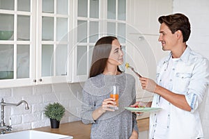 Portrait young couple smiling and hugging in the kitchen great time together in the kitchen at home