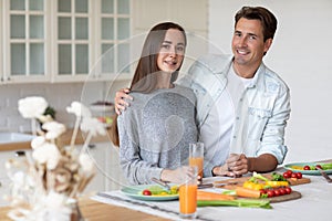 Portrait young couple smiling and hugging in the kitchen great time together in the kitchen at home