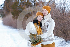 Portrait of young couple smiling and looking into camera in wint