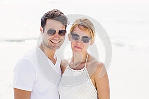 Portrait of young couple in sunglasses at beach