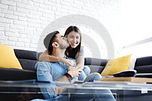 Portrait of Young Couple With Tablet PC Kissing