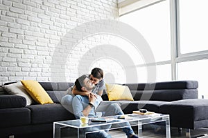 Portrait of Young Couple With Tablet PC Kissing