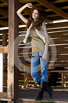 Portrait of young cowgirl in stetson with whip