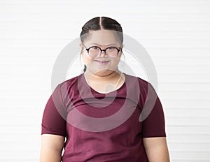 Portrait of a young and cute Asian down syndrome girl wearing eyesglasses and smile face