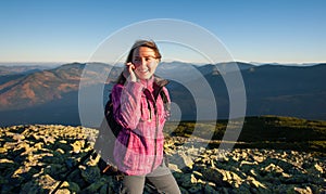 Portrait of young cute female backpacker talking cell phone