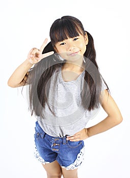 Portrait of young cute girl posting with two fingers. photo