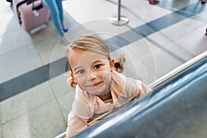 Portrait of young cute little girl being playful in check in at airport