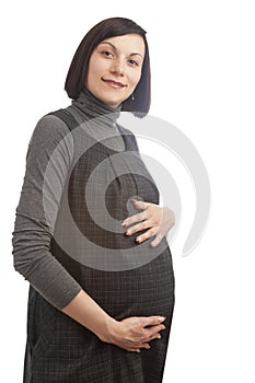 Portrait of Young Cute Positive Caucasian Brunette Pregnant Woman in Gray Dress Posing Over Pure White Background