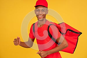 Portrait of a young delivery man showing thumb up.