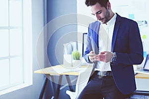 Portrait of young designer in front of laptop and computer while working.