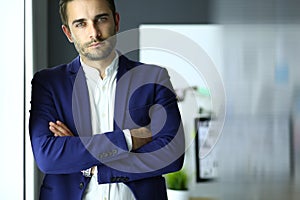 Portrait of young designer in front of laptop and computer while working.