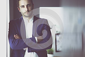 Portrait of young designer in front of laptop and computer while working.