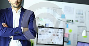 Portrait of young designer in front of laptop and computer while working.