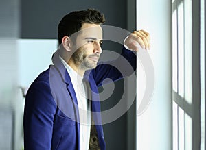 Portrait of young designer in front of laptop and computer while working.