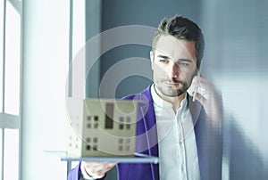 Portrait of young designer in front of laptop and computer while working.