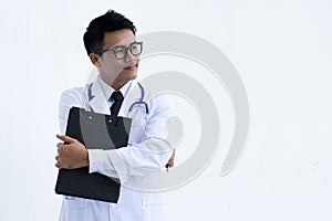 Portrait of young doctor or medic with folder and stethoscope