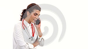 Portrait of a young doctor talking on the mobile phone and walking. Young medical professional with stethoscope and lab