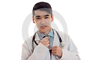 Portrait of a young doctor in a white lab coat close-up isolated on white background