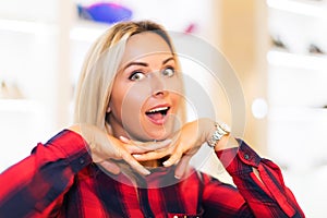 Portrait of young dreaming woman in the fashion store