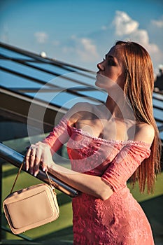 Portrait of young elegant blonde woman posing outdoors