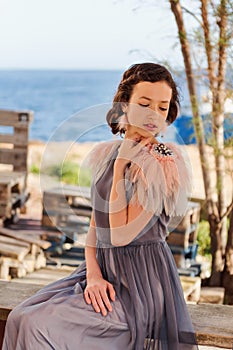 A portrait of a young elegant girl languidly bored at sea