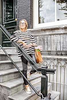 Woman on the stairs near luxury house