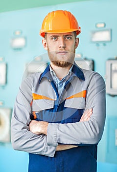 Portrait of young engineer at control room in factory