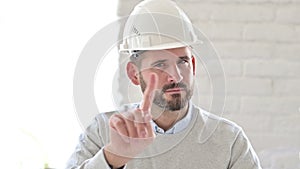 Portrait of young engineer showing no sign by finger