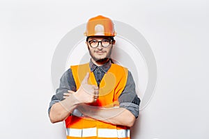 Portrait of young engineer showing thumbs up on white background.