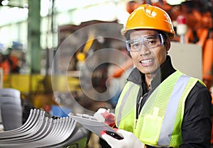 Portrait of young engineer taking notes