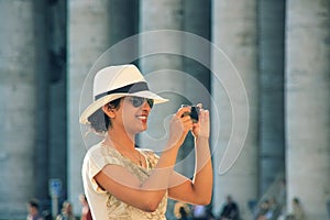 Portrait of young european black-haired girl-traveler travelling in VaticanCity