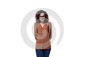 portrait of a young european curly woman with curled hair on a curling iron in a brown blouse isolated on a white