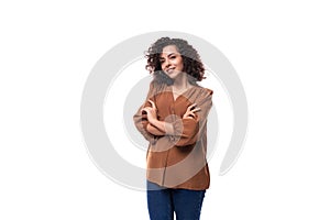 portrait of a young european curly woman with curled hair on a curling iron in a brown blouse isolated on a white