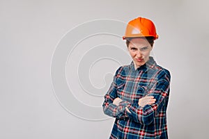 A portrait of a young evil girl builder looking into the camera. concept of job loss